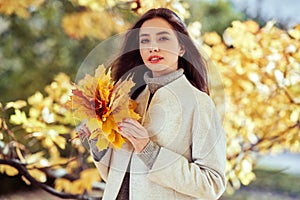 Portrait of a beautiful woman in an autumn park
