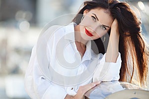 Portrait of a beautiful woman on the background of the sea and yachts