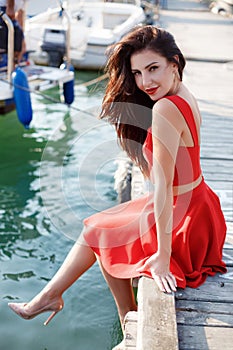 Portrait of a beautiful woman on the background of the sea and yachts