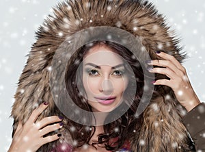 Portrait of a beautiful woman with beautiful make-up and manicure in a fur coat