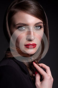 Portrait of a beautiful woman on a black background in a busines