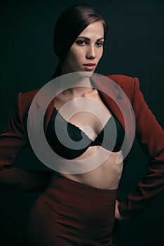 Portrait of a beautiful woman in a black bra on a dark background