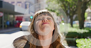 Portrait of a beautiful woman blowing a bubble while chewing gum in the city. Confident, carefree and happy young female
