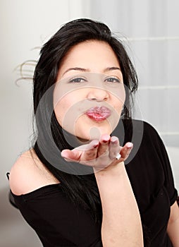 Portrait of beautiful woman blowing kiss