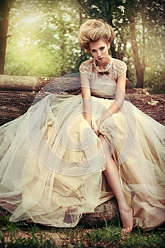 Portrait of a beautiful woman bride in a vintage wedding dress in nature in the forest