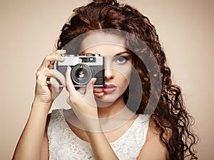 Portrait of beautiful woman with the camera. Girl photographer