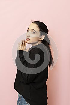 Portrait of a beautiful woman in casual clothing showing hand gesture begging, calling to help