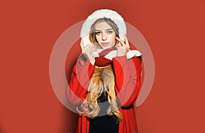 Portrait of a beautiful woman celebrate Christmas holidays isolated on red background. Young beautiful girl.