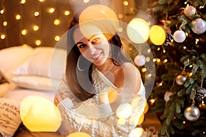 Portrait of a beautiful woman in the Christmas decorations, festive mood