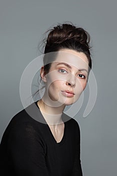 Portrait of beautiful woman with clean makeup and fancy hair bun