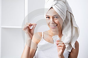 Portrait of beautiful woman cleaning teeth with dental floss