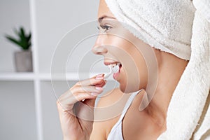 Portrait of beautiful woman cleaning teeth with dental floss