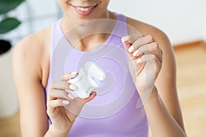 Portrait of beautiful woman cleaning teeth with dental floss