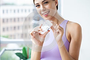 Portrait of beautiful woman cleaning teeth with dental floss