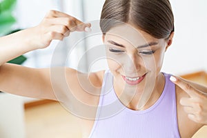 Portrait of beautiful woman cleaning teeth with dental floss