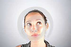 Portrait of a beautiful woman cogitate isolated on a white background