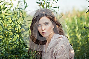 Portrait of beautiful woman. Cute model face. Girl on green grass outdoor
