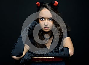 Portrait of the beautiful woman in devil costume