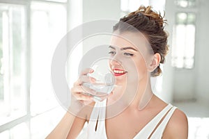 Portrait of a beautiful woman drinking water