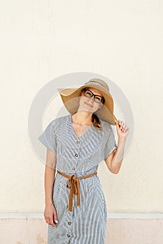 Portrait of a beautiful woman in elegant summer hat