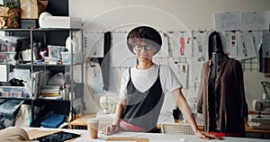 Portrait of beautiful woman fashion designer smiling in studio looking at camera