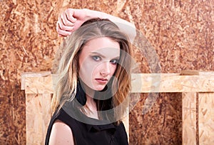 Portrait of beautiful woman fashion style posing on wooden wall