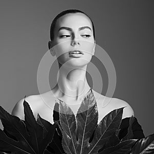 Portrait of a beautiful woman with grass leaves in her hands