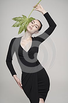 Portrait of a beautiful woman with grass leaves in her hands