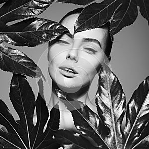 Portrait of a beautiful woman with grass leaves in her hands