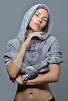 Portrait of the beautiful woman in grey hoody blouse