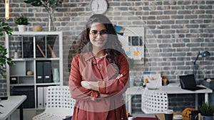 Portrait of beautiful woman happy office worker standing indoors and smiling