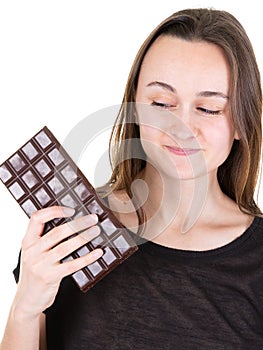 Portrait of beautiful woman holding looking back chocolate bar