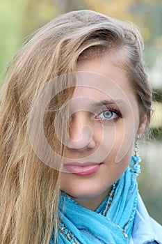 Portrait of beautiful woman with long blonde hairs. Closeup half face.