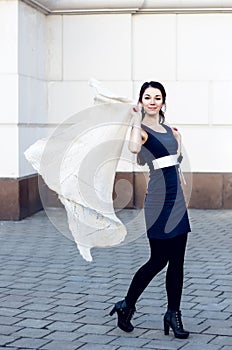 Portrait of a beautiful woman with long hair and a scarf flying