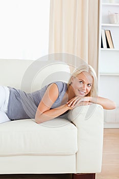 Portrait of a beautiful woman lying on a sofa