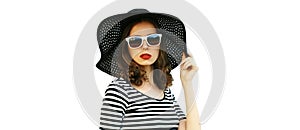 Portrait of beautiful woman model wearing black round summer hat, striped dress isolated on white background