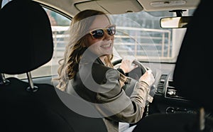 Portrait of beautiful woman in the new car