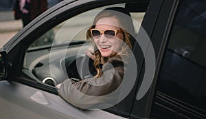 Portrait of beautiful woman in the new car