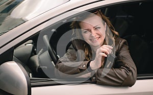 Portrait of beautiful woman in the new car