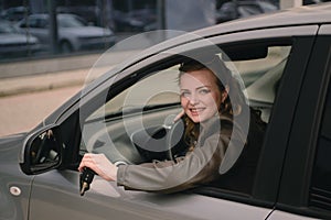 Portrait of beautiful woman in the new car