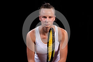 Portrait of beautiful woman playing tennis indoor. Isolated on black.