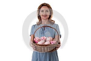 Portrait beautiful woman presenting a basket with pink flower composition, isolated on white background