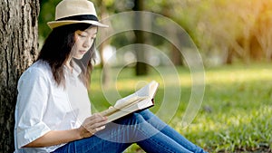 Portrait beautiful woman reading a book under the tree.Concept of recreation, education and study , curiosity, leisure time