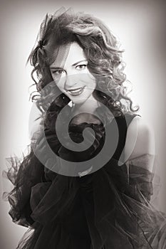 Portrait of a beautiful woman in a retro style in black dress