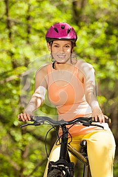 Portrait of beautiful woman riding her bicycle