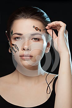 Portrait of a beautiful woman`s face with half human face and half face robot.