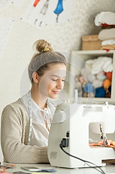 Portrait of a beautiful woman at sewing machine