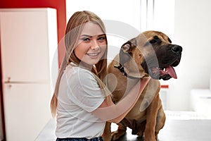 Portrait of beautiful woman with sick dog in vet hospital