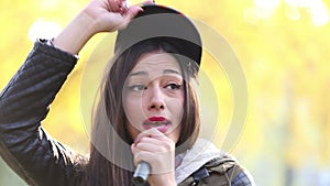 Portrait of beautiful woman singing into microphone and dancing