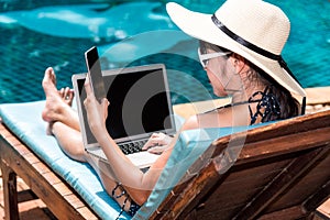 Portrait Beautiful Woman Sitting in deck chair and using laptop